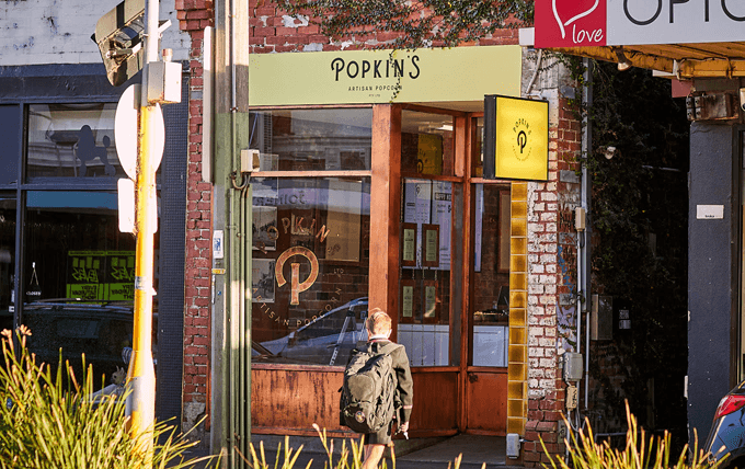 The front of a store with a person walking in front.